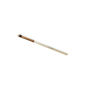 White fluffy makeup brush that says LABB on the handle on a white background. 